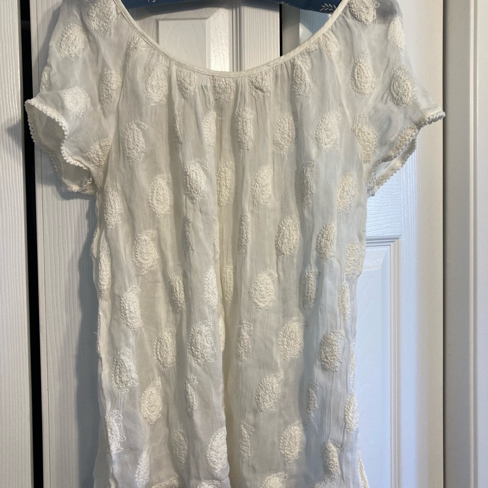 Women’s cream embroidered blouse.